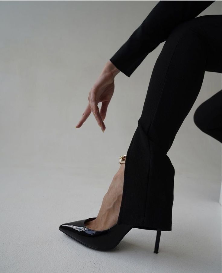 Pointed black heels and tailored black trousers